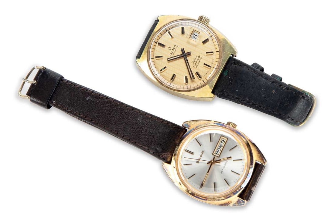 TWO GOLD PLATED WATCHES: comprising a gents gold-plated Bulova automatic day date strap watch; and a gents gold plated Olma Automatic date watch. (2) Last case diameter 36mm Watches are functioning but timekeeping not