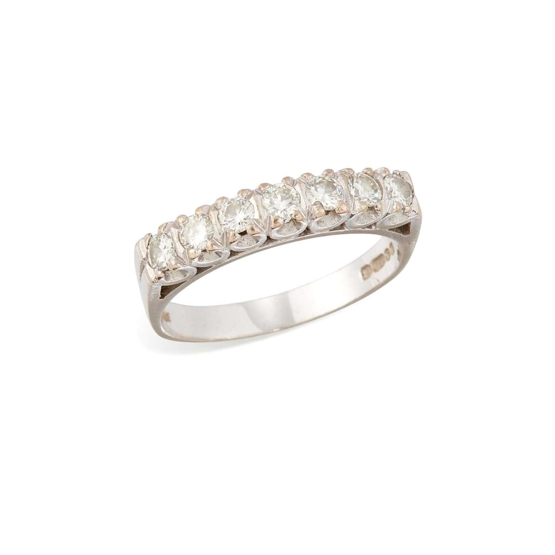 AN 18 CARAT WHITE GOLD DIAMOND HALF HOOP RING: seven round brilliant-cut diamonds in claw settings, hallmarked London 1976. Estimated total diamond weight 0.70 carat, ring size R, 4.9 grams Good condition. Estimated diamond colour: H/I/J,