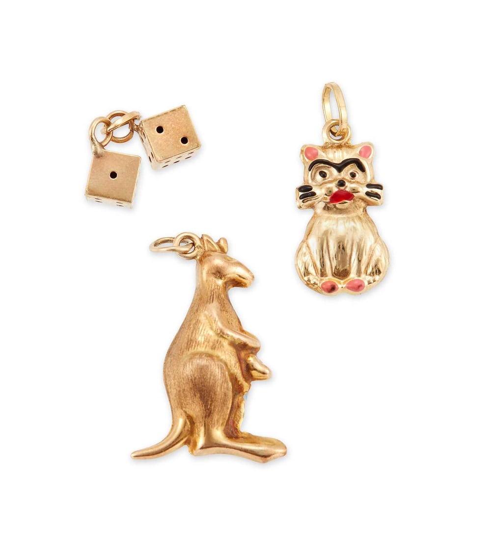 THREE 9 CARAT GOLD NOVELTY CHARMS: comprising a kangaroo, dice and a cat. (3) 2.5cm long and smaller, 2.5 grams gross Good condition