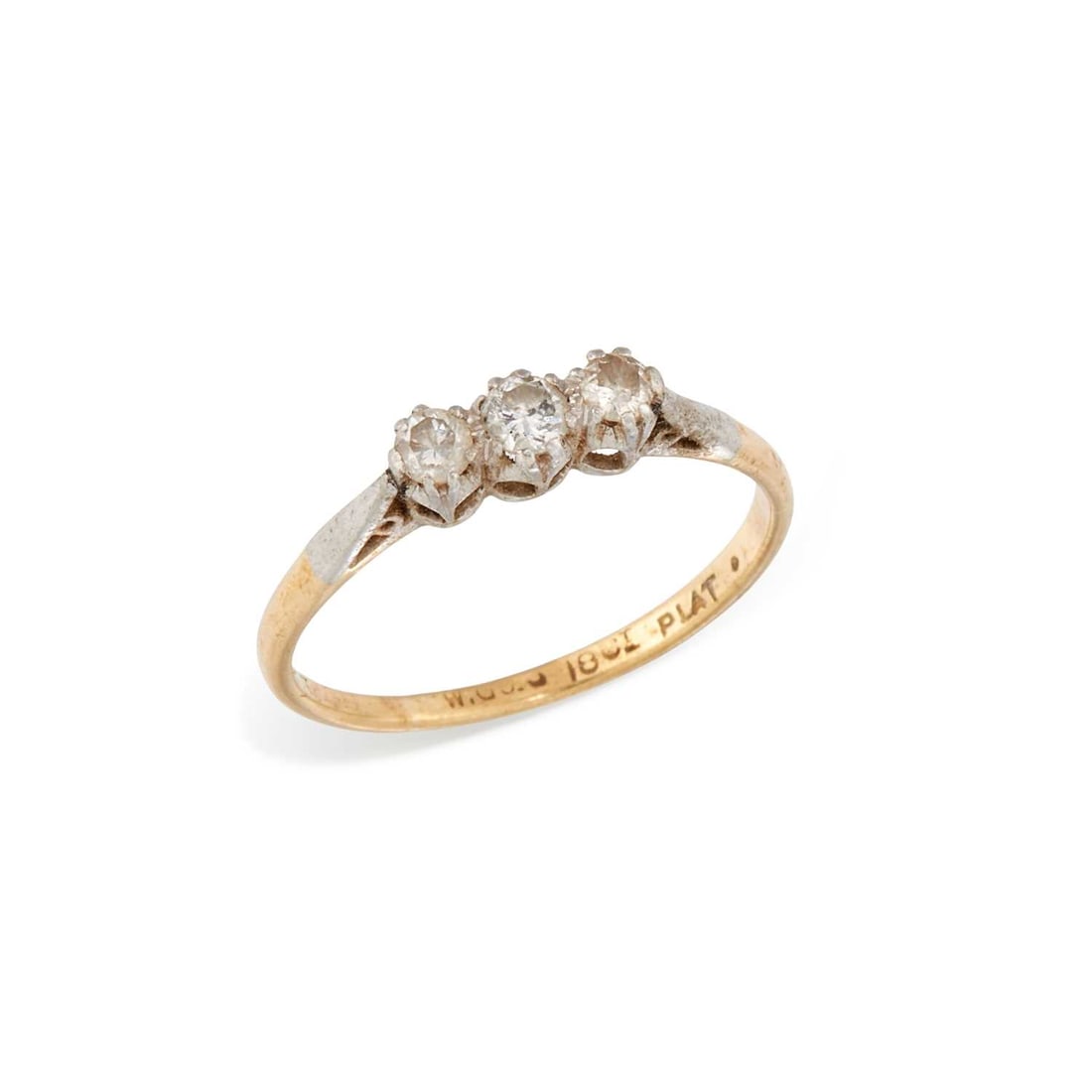 A DIAMOND THREE STONE RING: graduated round brilliant-cut diamonds to tapering shoulders, stamped '18CT PLAT'. Estimated total diamond weight 0.20 carat, ring size M, 1.9 grams Good condition. Estimated diamond colour: H/I,