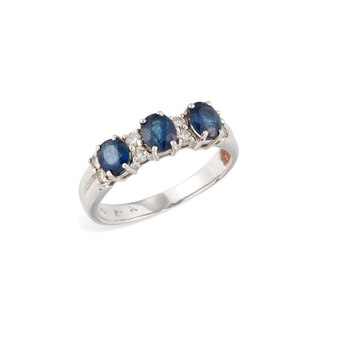 A SAPPHIRE AND DIAMOND RING: three oval-cut sapphires spaced by pairs of round brilliant-cut diamonds, stamped '750'. Ring size P, 3.6 grams Good condition.