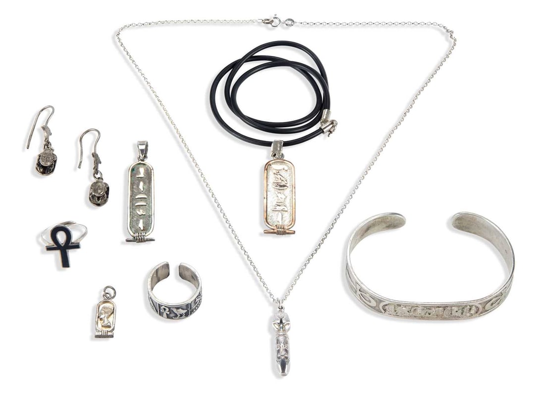 A COLLECTION OF SILVER EGYPTIAN REVIVAL JEWELLERY: comprising a pair of scarab pendant earrings, four pendants, two rings and a bangle. (8) 64 grams gross Light general wear, ankh ring with band misshapen