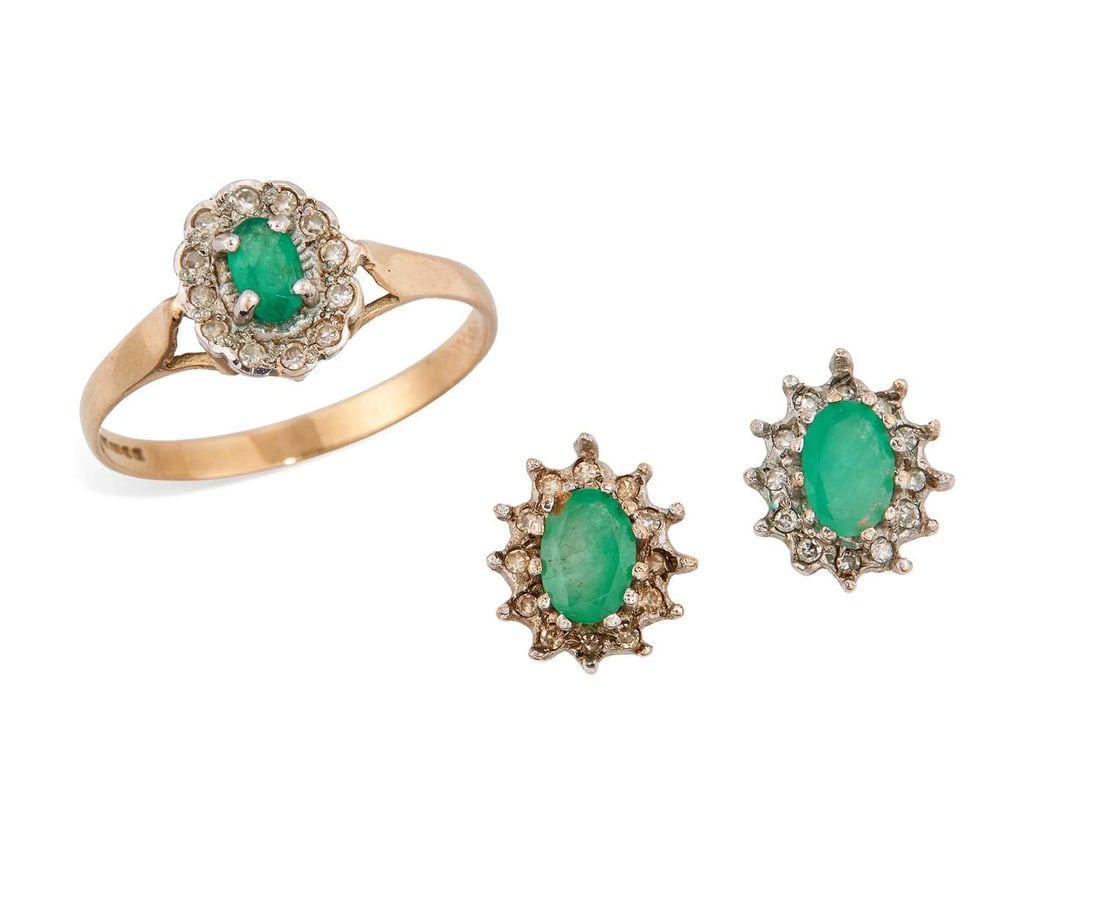 A PAIR OF 9 CARAT WHITE GOLD EMERALD AND DIAMOND CLUSTER STUD EARRINGS AND A RING: all with oval-cut emeralds within borders of diamonds, the earrings with post fittings, both hallmarked. (2) Earrings 1.1cm long, ring size O1/2, 2.7 grams gross Good condition