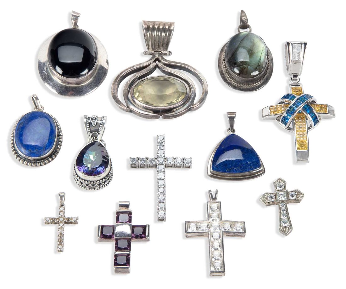 A COLLECTION OF SILVER GEM-SET PENDANTS: including various cross pendants, labradorite, lapis lazuli, mystic topaz, etc. (12) 6.5cm long and smaller, 156 grams gross Good condition
