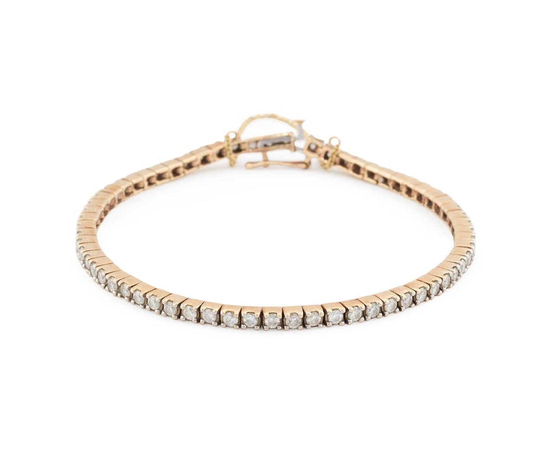 A 9 CARAT GOLD DIAMOND TENNIS BRACELET: hallmarked London. Total estimated diamond weight 2.55 carat, 18.5cm long, 11.2 grams Good condition. Estimated diamond colour: H/I, estimated diamond clarity: SI1/SI2