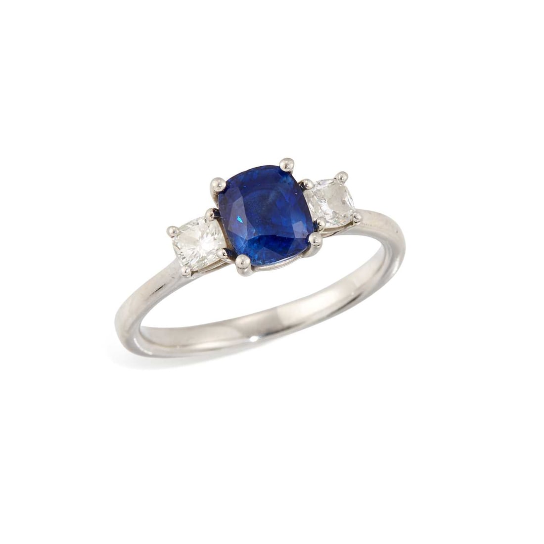 A SAPPHIRE AND DIAMOND THREE STONE RING: a cushion-cut sapphire flanked by cushion-cut diamonds, stamped 'PLT950'. Estimated total diamond weight 0.40 carat, ring size S1/2, 6.5 grams Good condition. Estimated diamond colour: H/I, estimated 