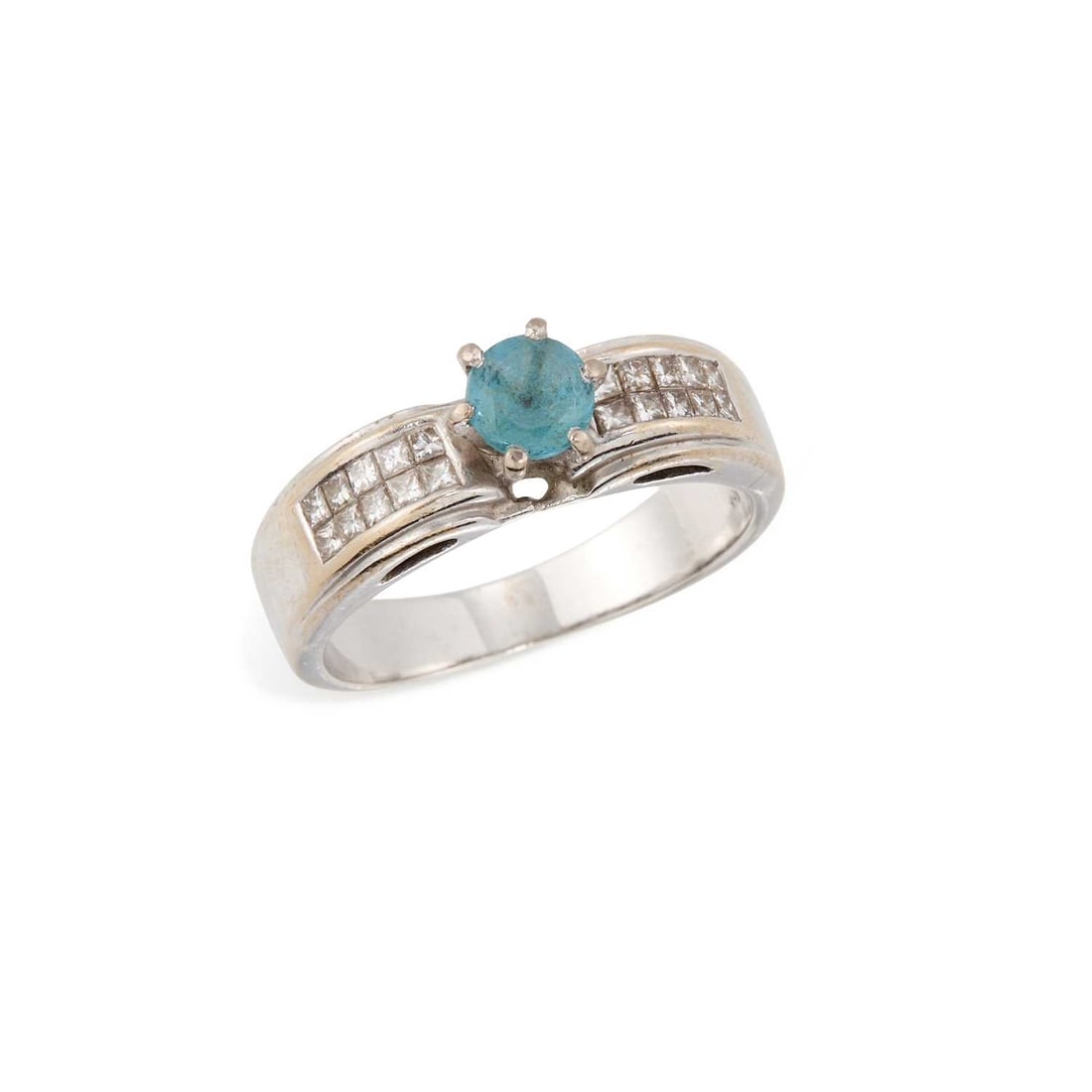 A BLUE TOURMALINE AND DIAMOND RING: a round-cut blue tourmaline in a high claw setting, to diamond-set shoulders, stamped '18K'. Ring size O1/2, 5.8 grams Good condition