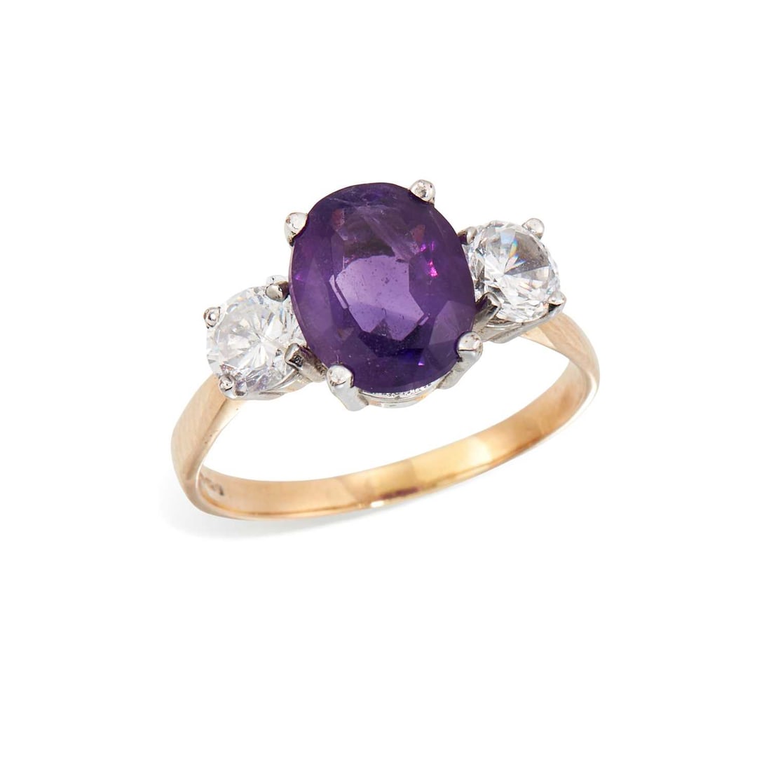 A 9 CARAT GOLD AMETHYST AND WHITE PASTE THREE STONE RING: an oval-cut amethyst flanked by round-cut white paste, hallmarked Birmingham. Ring size Q, 3.6 grams Good condition