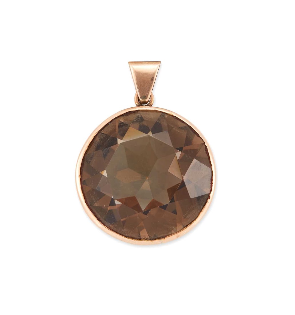 A SMOKY QUARTZ PENDANT: a round-cut smoky quartz in a bezel setting, unmarked. 3.3cm long, 11.2 grams Good condition. XRF tests as 9 carat gold