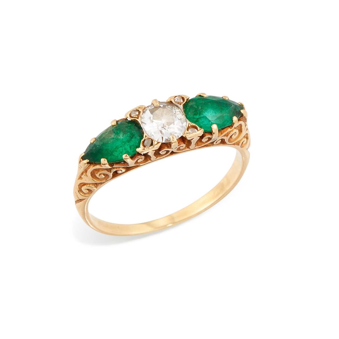 AN EMERALD AND DIAMOND RING: an old-cut diamond spaced by pear-cut emeralds, with diamond accents, above a carved gallery, unmarked. Estimated diamond weight 0.45 carat, ring size R, 4.2 grams Good condition. Estimated diamond