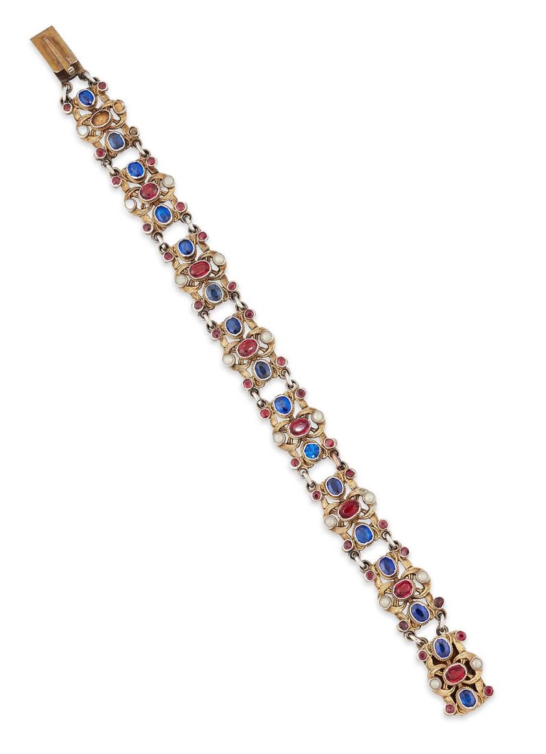 AN AUSTRO HUNGARIAN BRACELET: set with blue and red doublet stones and split pearls, to fancy links, unmarked. 18.5cm long, 25.6 grams One end link with three stones missing