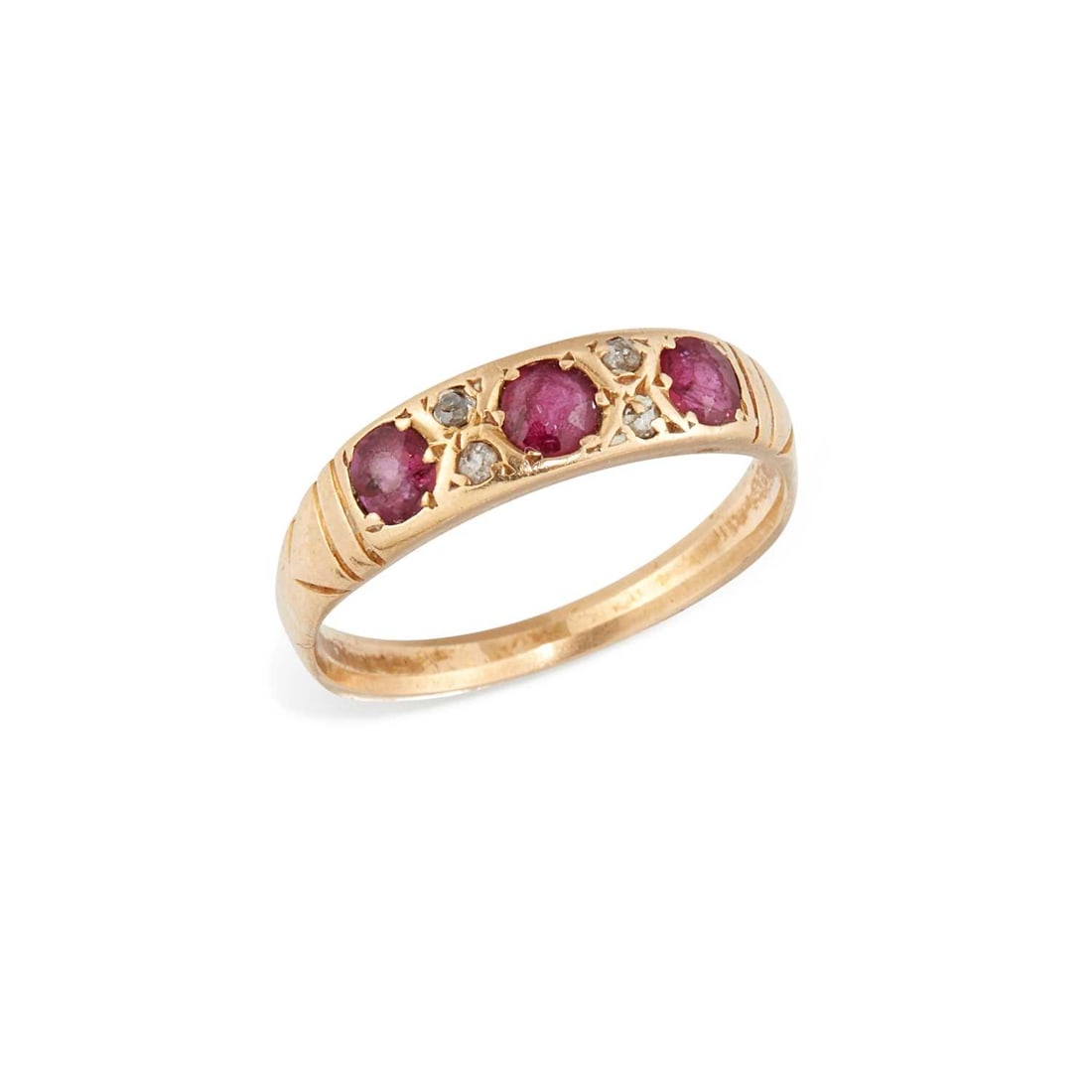 A RUBY AND DIAMOND RING: three cushion-cut rubies spaced by round-cut diamonds, unmarked. Ring size M, 3 grams Band worn to an angle, abrasion to the rubies, one diamond a later replacement