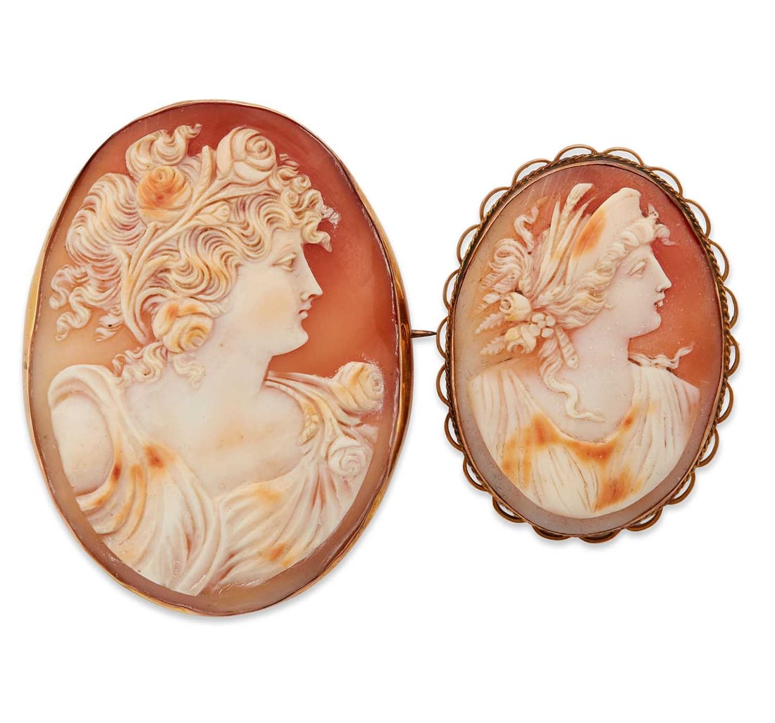 TWO 19TH CENTURY CAMEO BROOCHES: each carved with a classical female bust, stamped '9CT'. (2) 6.3cm by 4.7cm and smaller, 36.8 grams gross Good condition