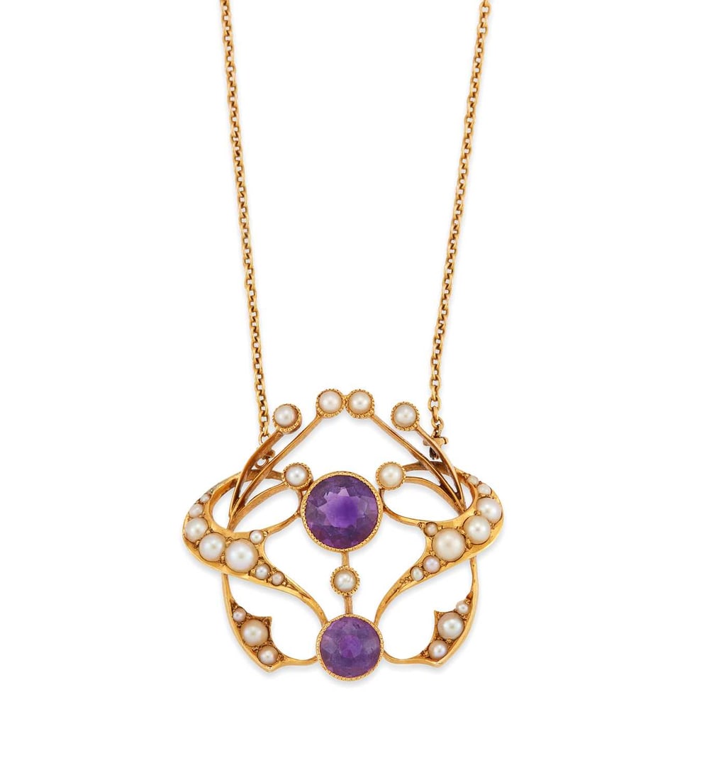 AN ART NOUVEAU AMETHYST AND SEED PEARL PENDANT NECKLACE: two round-cut amethysts within a seed pearl set whiplash frame, to a fine chain, stamped '15CT'. Pendant 2.5cm long, chain 40cm long, 5.6 grams Good condition. Would have had a pendant drop, now defic