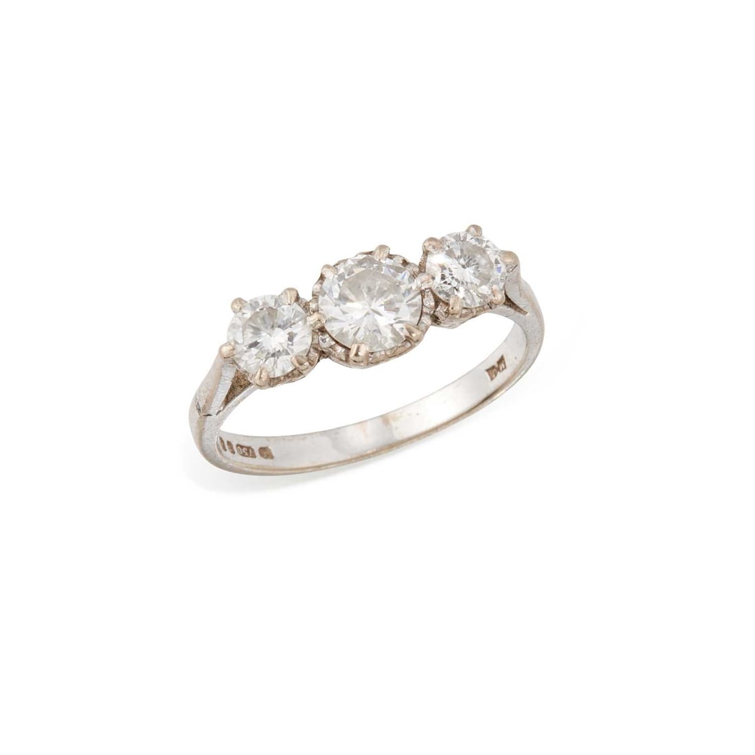 AN 18 CARAT WHITE GOLD DIAMOND THREE STONE RING: graduated round brilliant-cut diamonds in illusion settings, stamped hallmarked London 1975. Estimated total diamond weight 1.30 carat, ring size N1/2, 3.6 grams Good condition. Estimated diamond