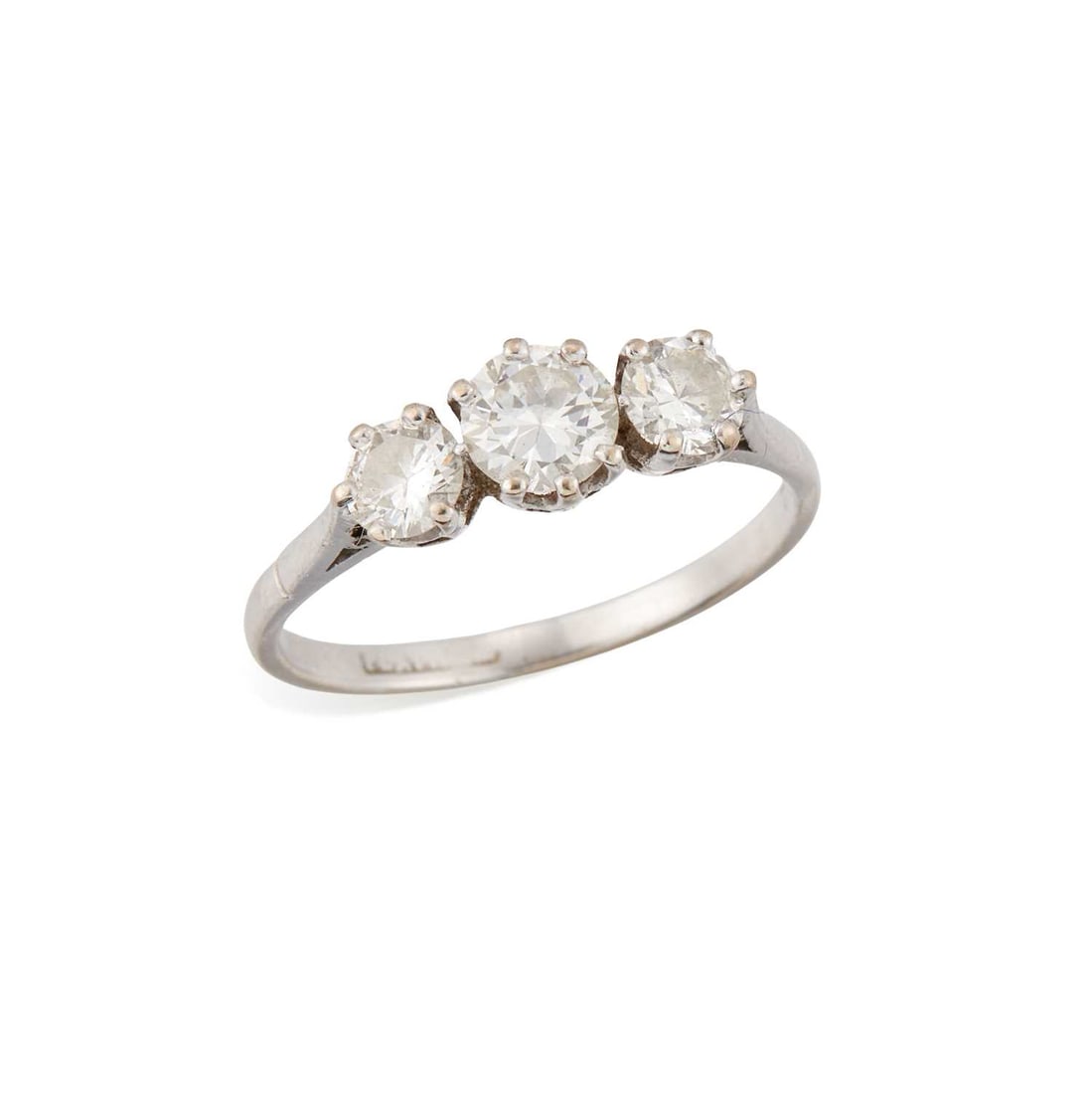 A DIAMOND THREE STONE RING: graduated round brilliant-cut diamonds in claw settings, stamped 'platinum'. Estimated total diamond weight 1.00 carat, ring size Q, 3.2 grams Small chip to the girdle of the principal diamond.