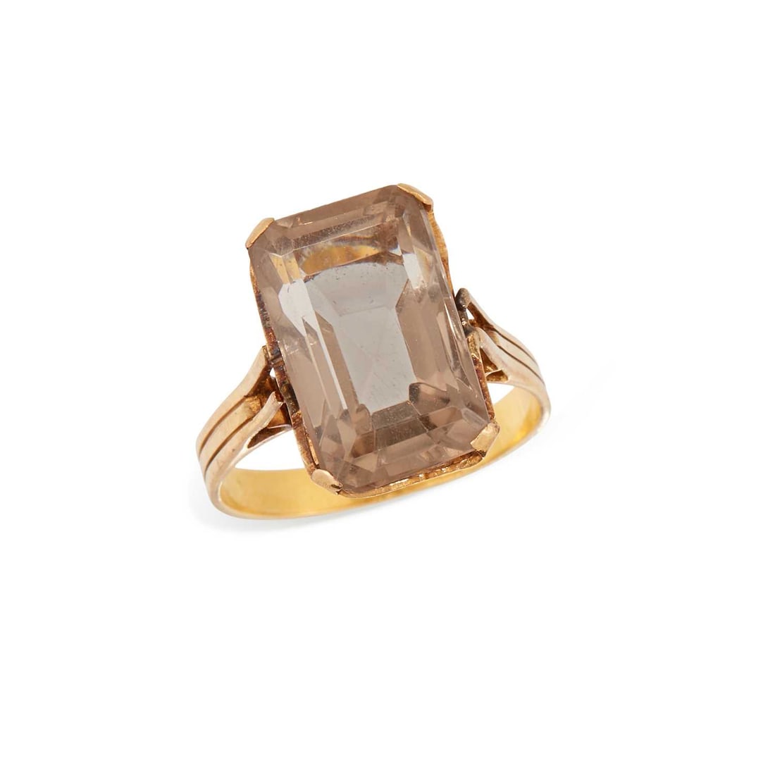 A SMOKY QUARTZ RING: an octagonal-cut smoky quartz to a foliate gallery and fluted band, unmarked. Ring size M1/2, 5.1 grams Discolouration to the band