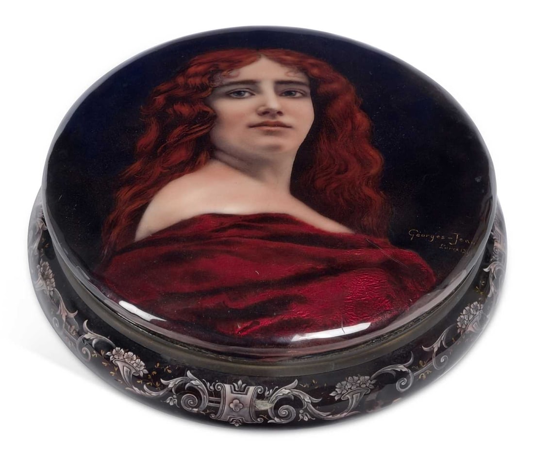 A LIMOGES ENAMEL BOX AND COVER GEORGES-JEAN: signed Georges-Jean, Paris and dated 1891, the cover painted with a bust portrait of a young woman with flowing auburn hair, bare-shouldered and draped in red, against a deep blue ground, the sides