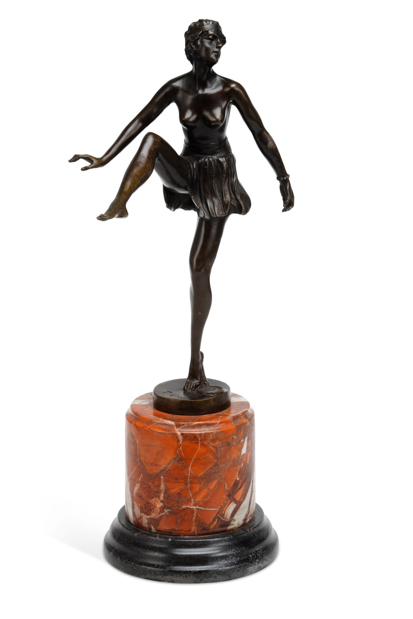 AN ART DECO BRONZE FIGURE OF A DANCER: modelled standing on one leg with the other raised and the arms outstretched, wearing a short pleated skirt and a headband, on a socle and stepped rouge marble and black marble base. 48cm high