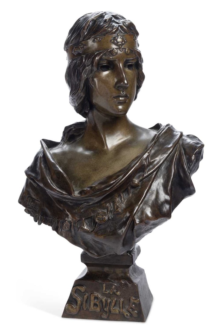 AN EMMANUEL VILLANIS BRONZE BUST OF LA SIBYLLE: signed E. Villanis, the title LA SIBYLLE cast to the socle, modelled as a young woman gazing to one side, wearing a jewelled headband, on a tapering plinth, with the seal of the Societe des Bronzes de