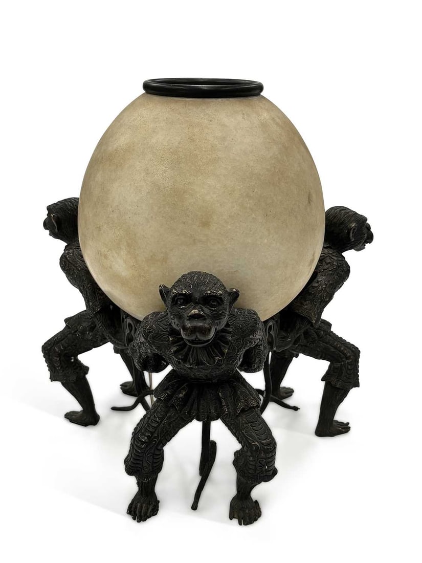 A BRONZE MONKEY LAMP LATE 20TH CENTURY: well cast as three monkeys in 18th Century costume, supporting a large marble, egg shaped shade. 38cm high