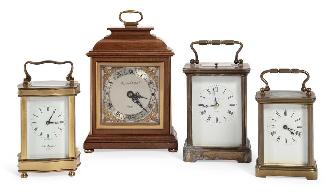 A MAPPIN & WEBB MANTEL TIMEPIECE AND THREE CARRIAGE CLOCKS: comprising the first in a mahogany case with brass carrying handle, the silvered dial with Roman chapter ring and gilt spandrels signed Mappin & Webb Ltd. and An Elliott Clock, Made in England, on