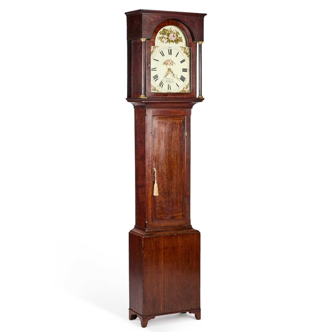 AN EARLY 19TH CENTURY OAK THIRTY-HOUR LONGCASE CLOCK SIGNED W. ROBINSON, LEYBURN: the 12-inch painted dial decorated with sprays of roses, date crescent, the case with a flat hood and rectangular door, raised on bracket feet. 217cm high With weight and pendulum.