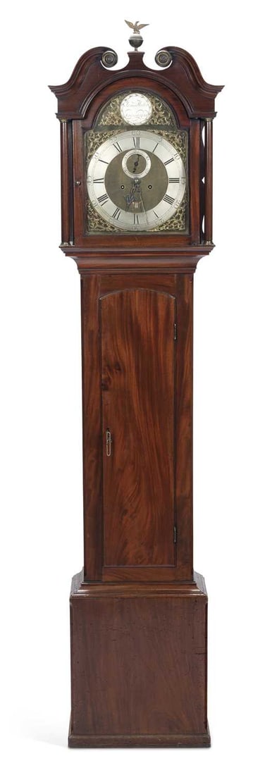 A GEORGE III MAHOGANY LONGCASE CLOCK JAMES HUTTON, EDINBURGH: the swan neck pediment with a brass ball and eagle finial and rosettes above an arched glazed hood door flanked by columns, the trunk with an arched flame mahogany door, on a plinth base, the 12-inch 