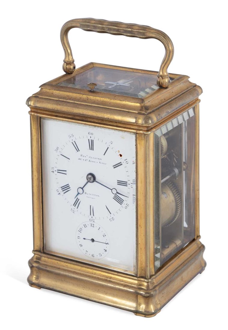 A BRASS CARRIAGE TIMEPIECE WITH ALARM CIRCA 1870: the moulded case with a hinged carrying handle and bevelled glass panels, the white enamel dial with Roman numerals and an outer minute track, signed Fras Glading, 46 & 47 King's Road, Brighton, with 