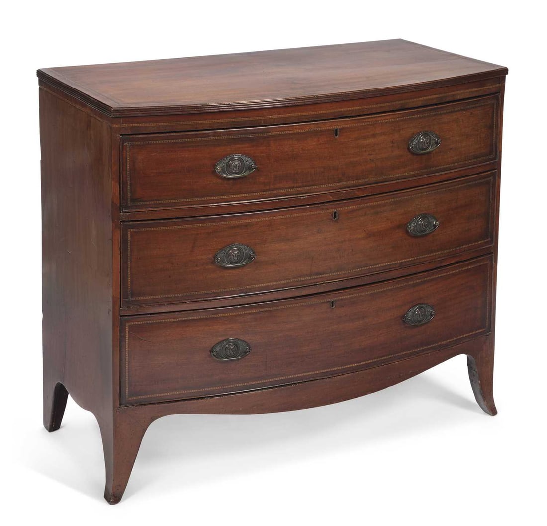 A GEORGE III MAHOGANY BOW FRONT CHEST OF DRAWERS: the moulded top with chequer stringing above three long graduated drawers, each crossbanded and inlaid with chequer stringing, with oval brass plate handles, on splayed bracket feet. 92cm high, 104cm 