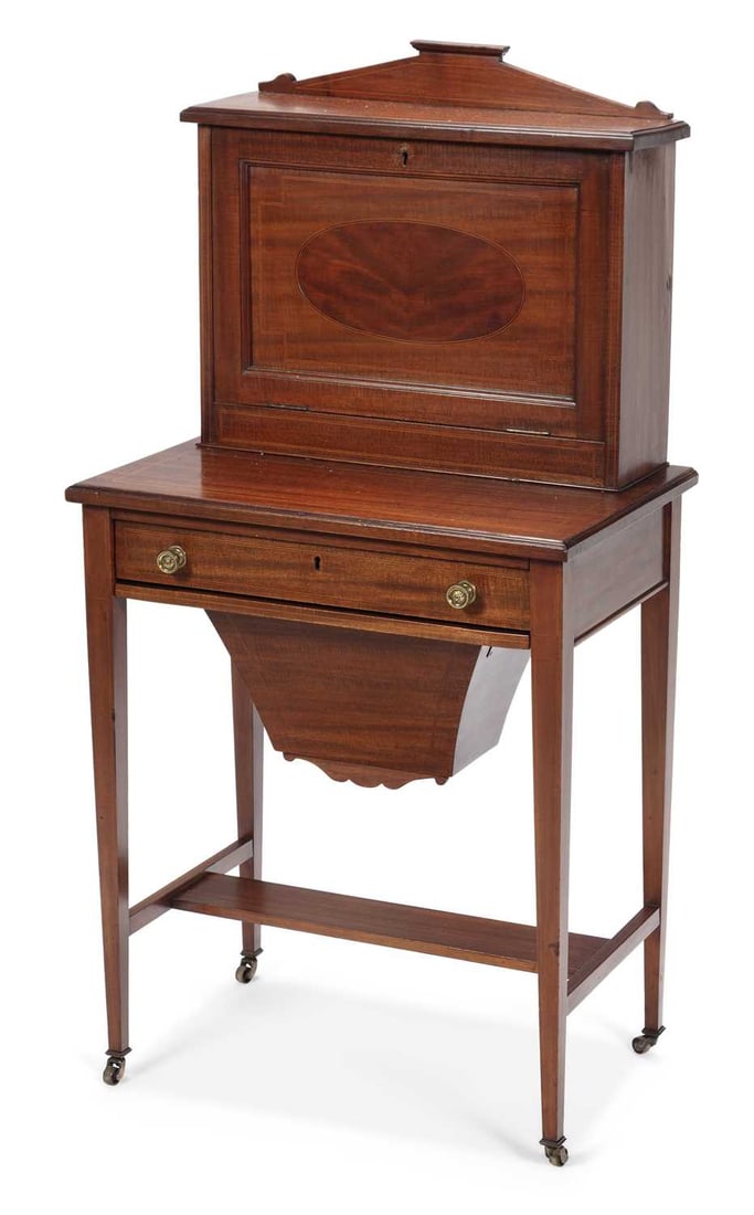 AN EDWARDIAN INLAID MAHOGANY LADY'S WRITING DESK: the raised superstructure with an architectural pediment above a fall front inlaid with an oval panel within boxwood stringing, enclosing a fitted interior of pigeonholes, shelves and a small drawer, 