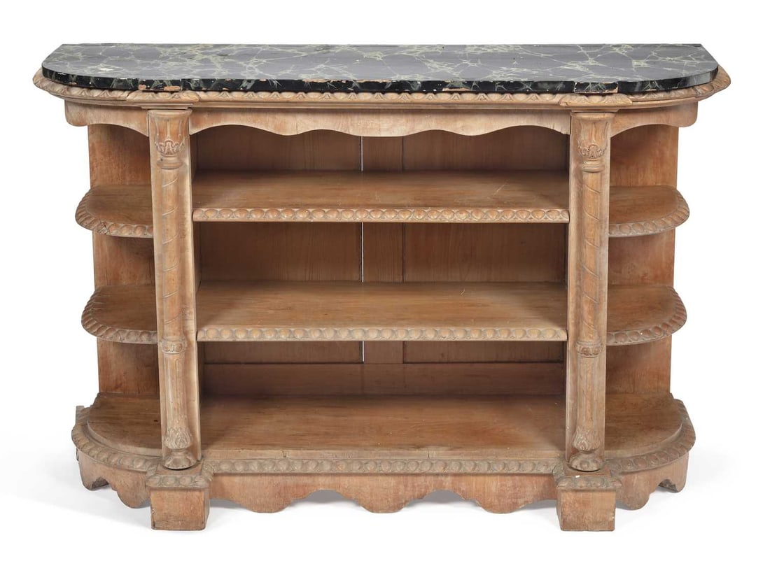 A CARVED OPEN BOOKCASE 19TH CENTURY: the shaped simulated marble top above three open shelves flanked by bowed end shelves, divided by turned and carved columns with foliate capitals, the shelf edges carved with egg and dart moulding,