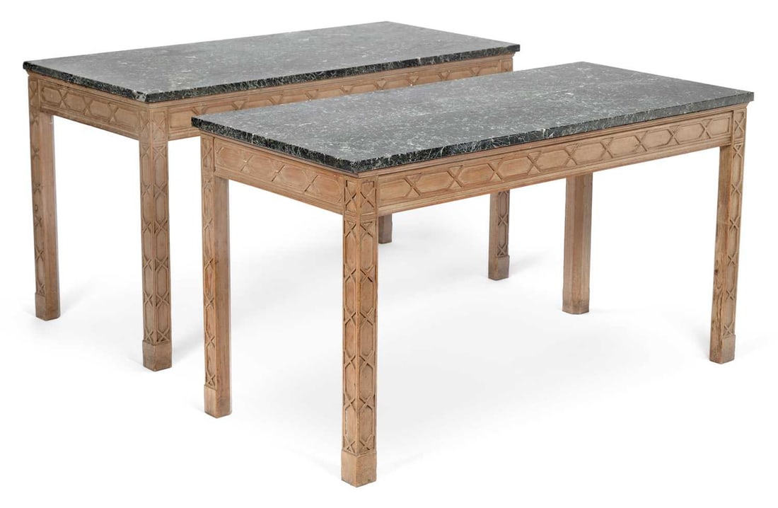 A PAIR OF GEORGE III STYLE PINE SIDE TABLES: in the Chippendale taste, each with a veined green marble top above a blind fret carved frieze, on square section legs carved with blind fret. (2) 76cm high, 137cm wide, 63.5cm deep