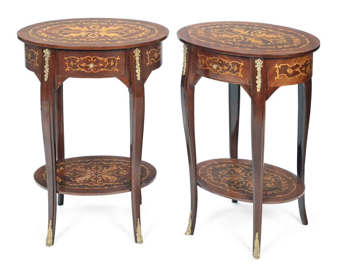 A PAIR OF MARQUETRY OVAL OCCASIONAL TABLES: in the Louis XV taste, each with an oval top inlaid with scrolling foliate marquetry within a crossbanded border, above a frieze drawer, raised on slender cabriole legs applied with gilt metal mounts 