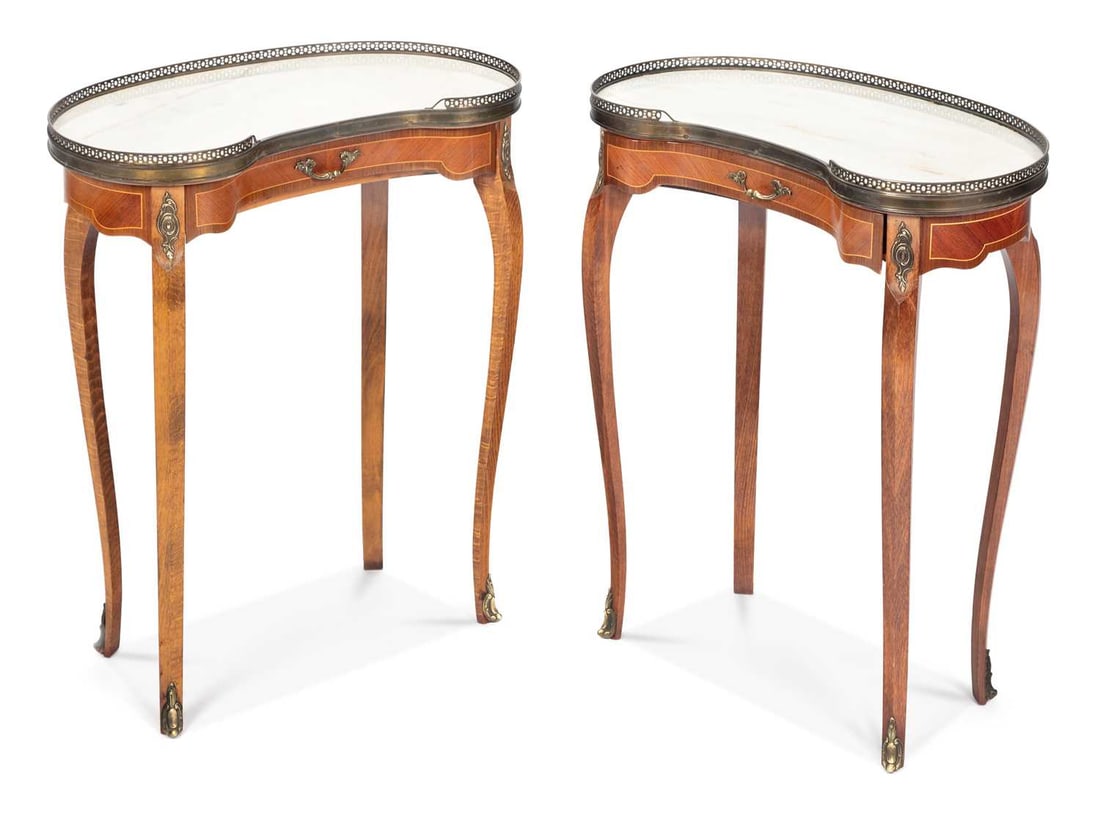 A PAIR OF MARBLE-TOPPED KIDNEY-SHAPED OCCASIONAL TABLES: in the Louis XV taste, each with a kidney-shaped marble top within a pierced brass gallery, above a frieze drawer, the crossbanded frieze applied with gilt-metal mounts, raised on slender cabriole