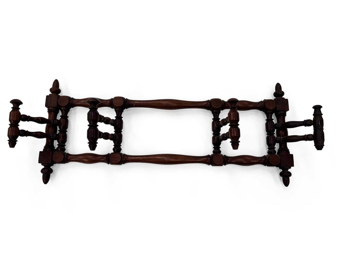 A VICTORIAN MAHOGANY FOLDING CLOTHES AIRER: the ring turned bars pivoting between turned uprights with acorn finials and squared blocks. 67cm long (closed)