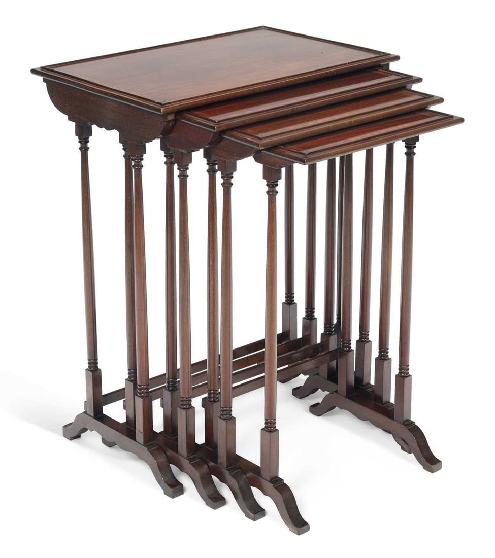 A NEST OF FOUR EDWARDIAN MAHOGANY QUARTETTO TABLES: each with a rectangular top with a moulded edge and satinwood banding within stringing, raised on slender turned column supports joined by a stretcher, on splayed shaped feet. (4) Largest 72.5cm