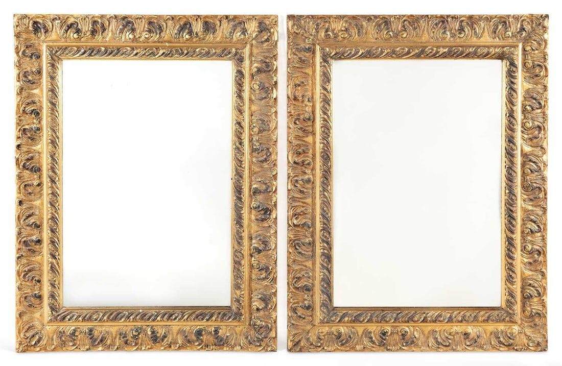 A PAIR OF GILT COMPOSITION WALL MIRRORS: each with a rectangular plate within a deep moulded frame, the inner border with spiral gadrooning and the outer with a band of acanthus and palmette ornament. (2) 104cm high, 76cm wide