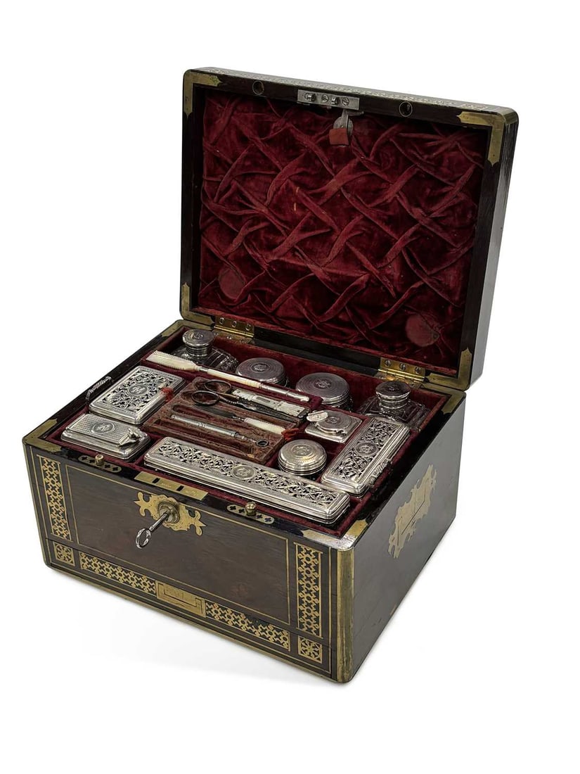 A GEORGE IV BRASS INLAID ROSEWOOD DRESSING CASE: the silver fittings by George Reid, London 1829, the case inlaid with brass stringing and pierced foliate bands, the cover set with an engraved plate inscribed Mrs Campbell, of Ardpatrick, opening to 