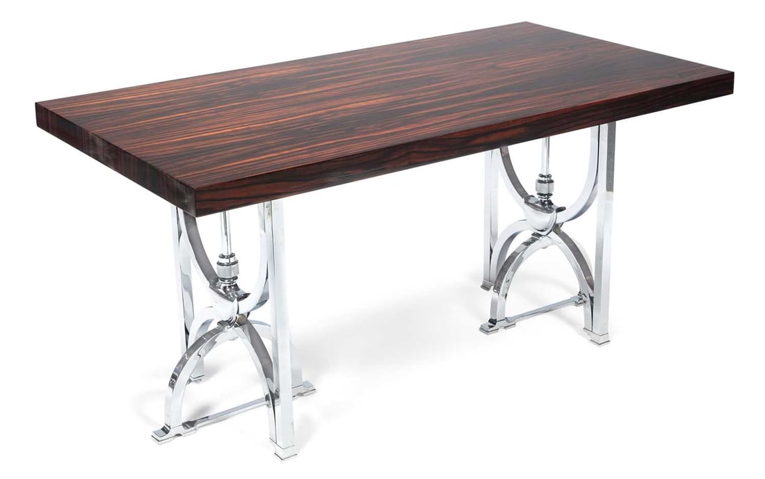 AN ART DECO STYLE MACASSAR EBONY VENEERED AND CHROME CONSOLE TABLE: the rectangular top raised on twin polished chrome trestle supports with curved stretchers and stepped feet. 63cm high, 130cm long, 70cm wide