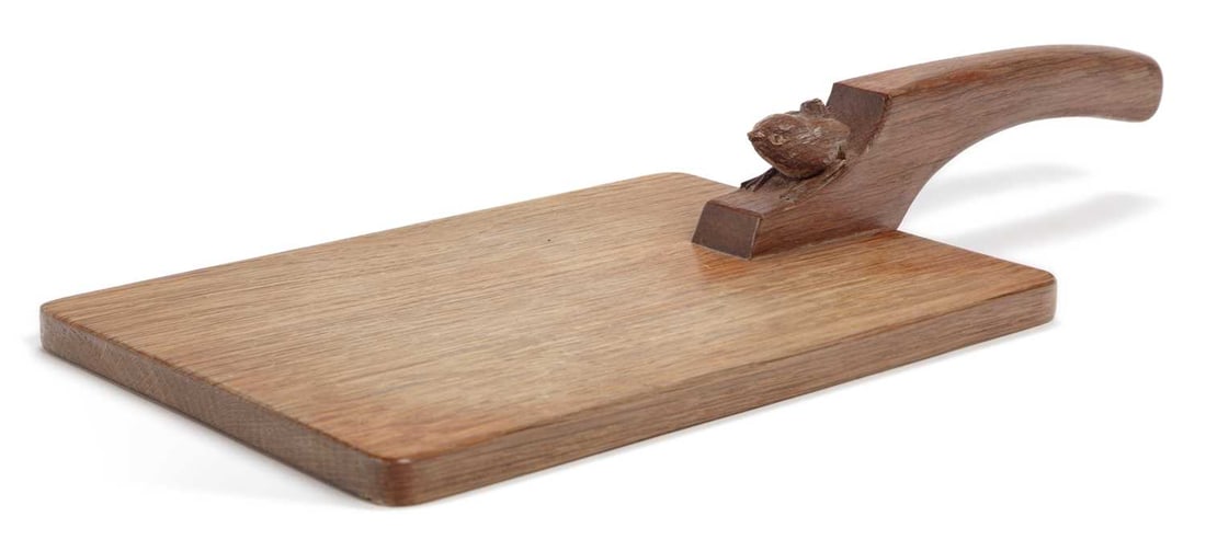 BOB HUNTER OF THIRLBY A WRENMAN CHEESEBOARD: rectangular form, the handle carved with a wren. 39.5cm long, 17.5cm wide