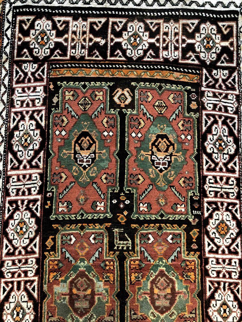 ANTIQUE KAZAK, 3'11" X 8'0", 120 X 244 CM: This is a rare Caucasian rug, known as Kazak. This rug's design originated and derived from a front entrance "Wooden Village Door." Date: circa 1900. Colours: Rose centre motifs on brown-banded by ivo
