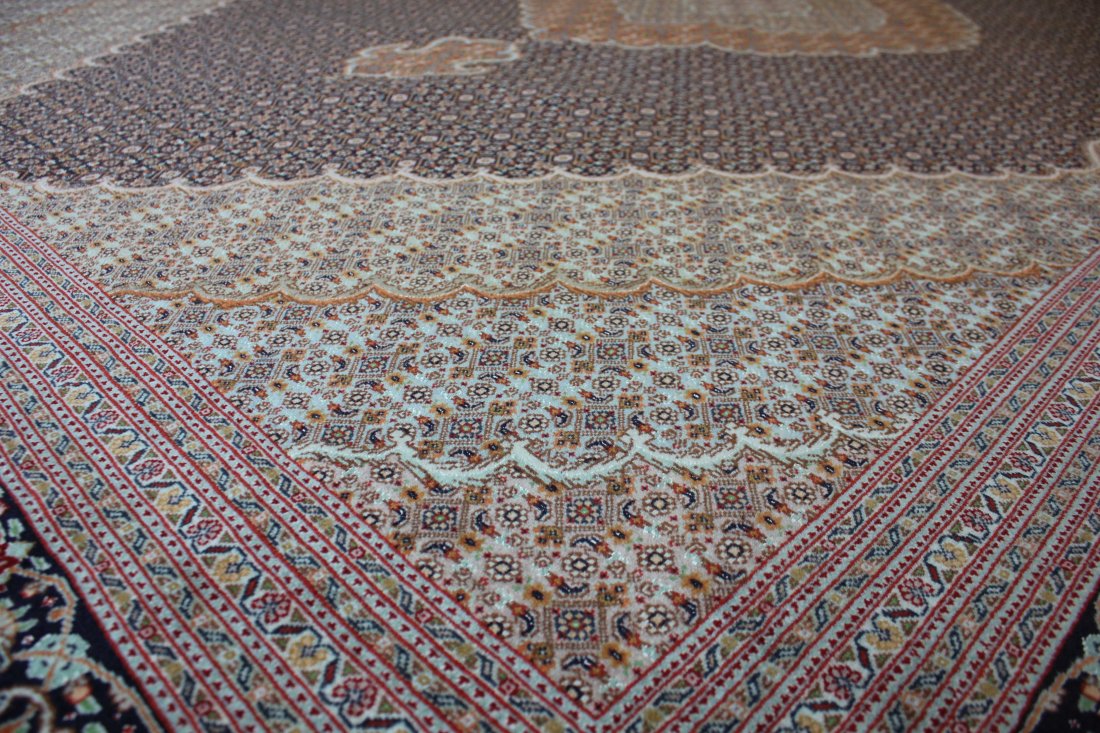 GENUINE MAHI TABRIZ, 8'2" X 11'5, 249 X 294 CM: Region: Genuine Tabriz. Workshop: unknown. Knot Density (sq inches): 306. Weave: hand-knotted. Warp (foundation): cotton. Pile: virgin wool & pure silk. Pattern: Mahi (Fish) design. Colours: Black and
