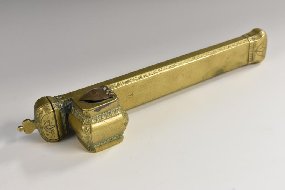 A Persian brass scribe's qalamdan pen case and inkwell,: A Persian brass scribe's qalamdan pen case and inkwell, hinged covers, 25.5cm long, 19th century