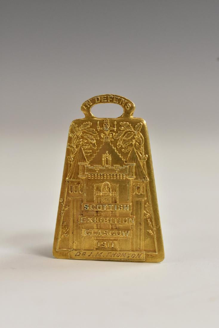 The Scottish Exhibition, Glasgow 1911 - a Scottish Art: The Scottish Exhibition, Glasgow 1911 - a Scottish Art Nouveau 15ct gold medal fob, inscribed to Dr J.M. Thomson, 3cm long, Elkington & Co, London 1911, 7.9g