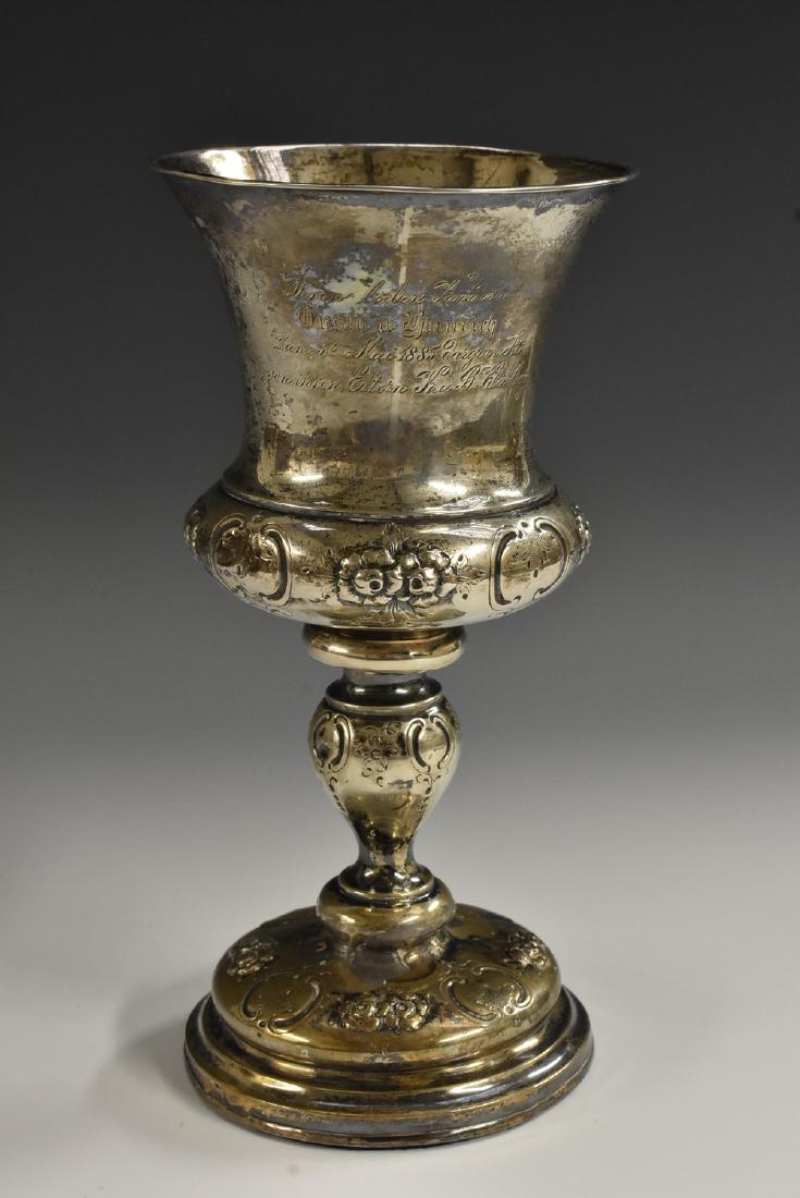 A 19th century silver coloured metal campana chalice,: A 19th century silver coloured metal campana chalice, chased and engraved with flowers and foliage, knopped stem, domed foot, 21.5cm high, c.1880