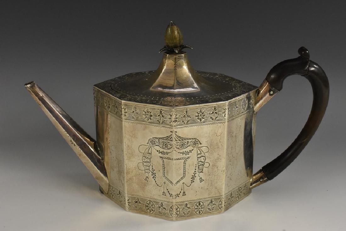 A George III Neo-Classical silver lozenge shaped: A George III Neo-Classical silver lozenge shaped teapot, flush-hinged lofty domed cover with pineapple finial, bright-cut engraved, scroll-capped fruitwood handle, 29.5cm long, George Gray, London 179