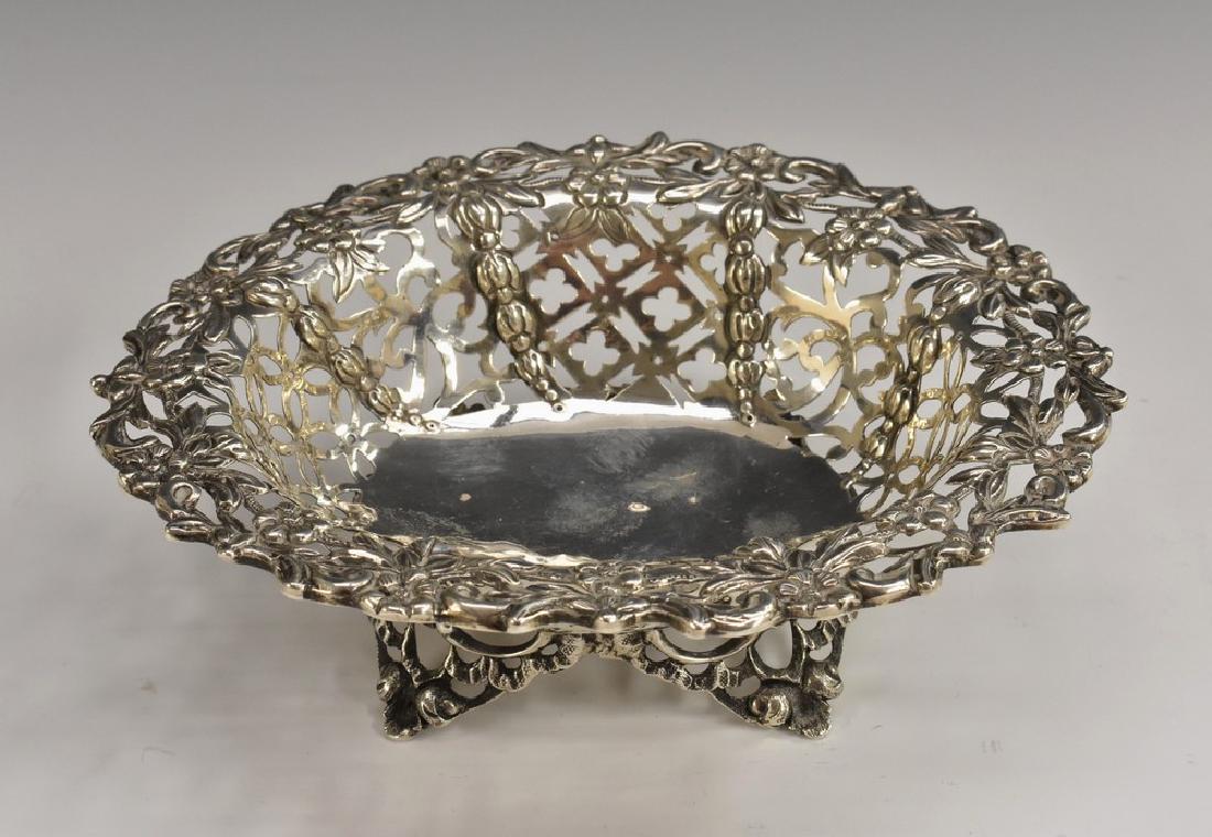 A Victorian silver shaped oval sweetmeat dish, pierced: A Victorian silver shaped oval sweetmeat dish, pierced and embossed with flowers, scrolling leaves and quatrefoil tracery, outswept feet, 15cm wide, Charles Stuart Harris, London 1893, 3oz
