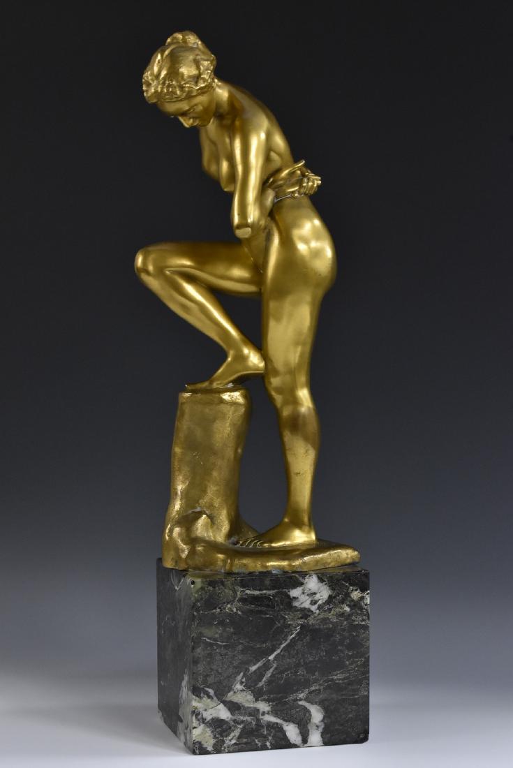 Max Klinger (1857 - 1920), a gilt patinated bronze, The: Max Klinger (1857 - 1920), a gilt patinated bronze, The Bather, she stands nude, one foot raised upon a pedestal, signed in the maquette with monogram: MK, foundry mark for Aktien-Gesellschaft Gladenb