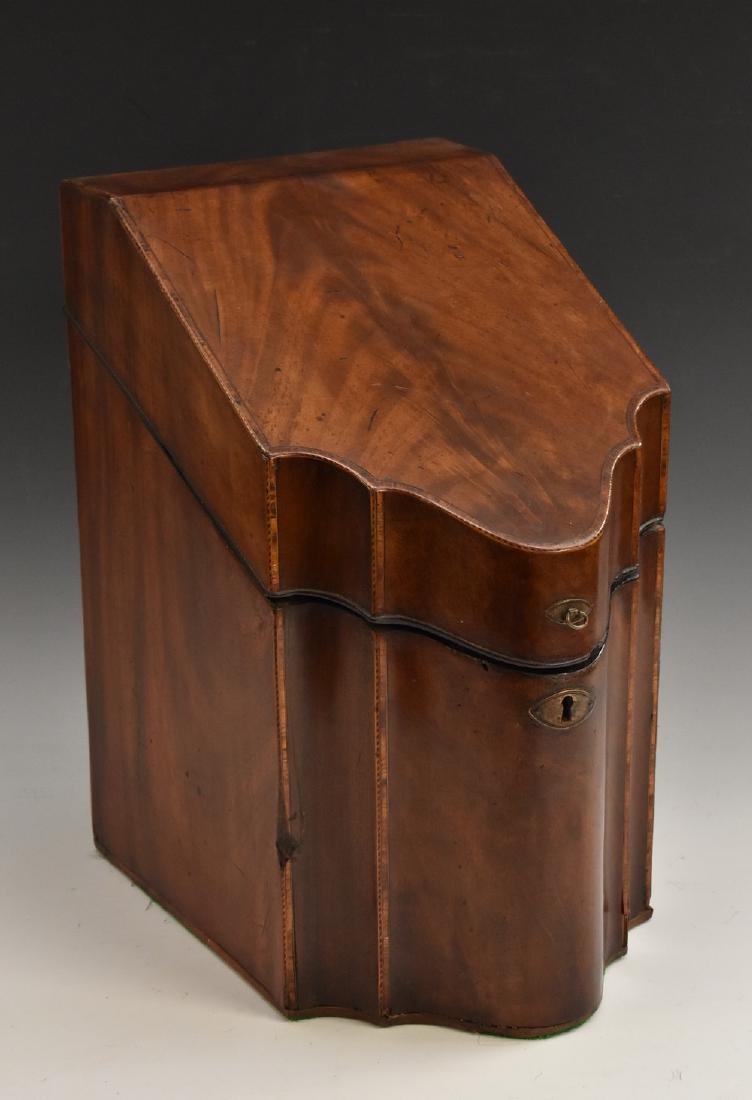 A George III mahogany commode fronted knife box, the: A George III mahogany commode fronted knife box, the hinged cover inlaid with a marquetry eight-pointed star within a rope twist to verso, enclosing a vacant interior, outlined throughout with satinwo